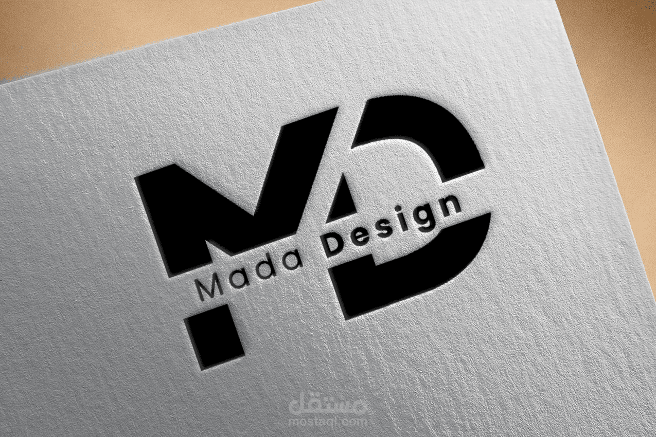 شعار مادا ديزاين منقوش على ورق بخط احادي